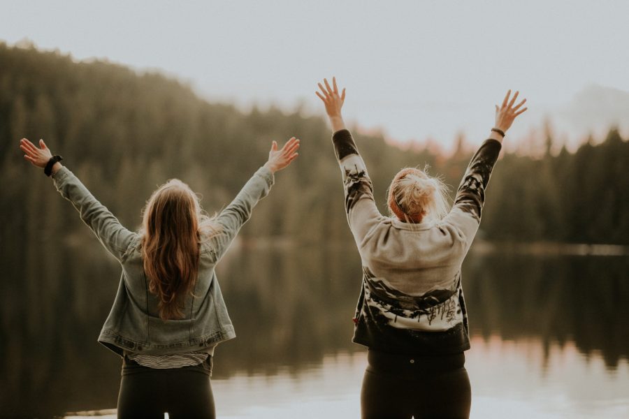 two women lifting up their hands